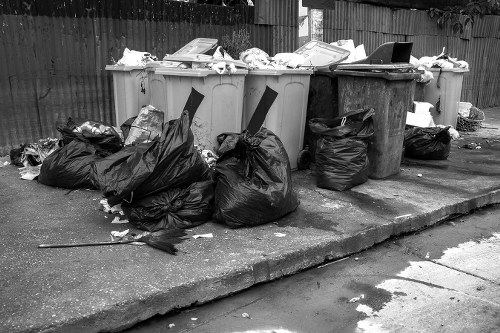 Construction site with builders clearing waste in Norbiton